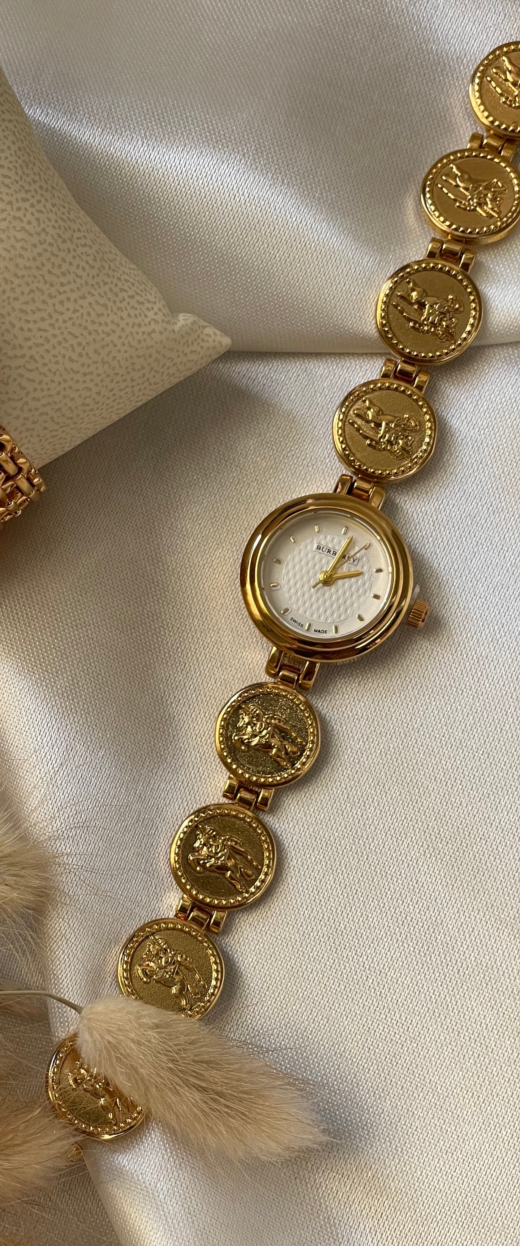 Impériale Roma – Montre Médaillon Dorée signée Burberry